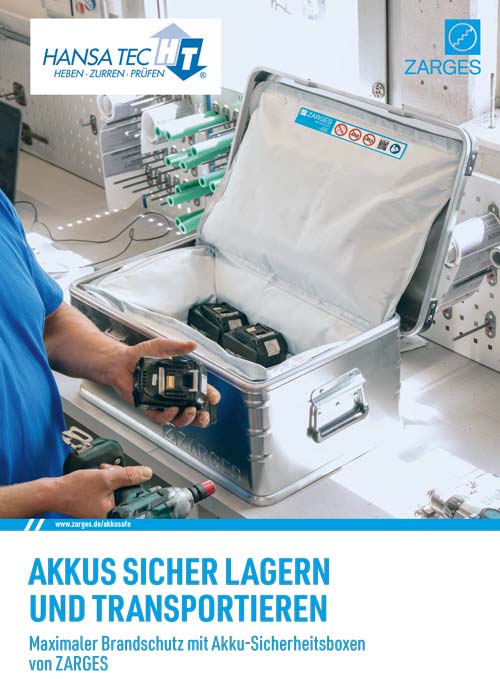 Ein grauer Sicherheitskoffer mit Akkus, offen auf Werkbank, daneben Werkzeug und Firmenlogos.